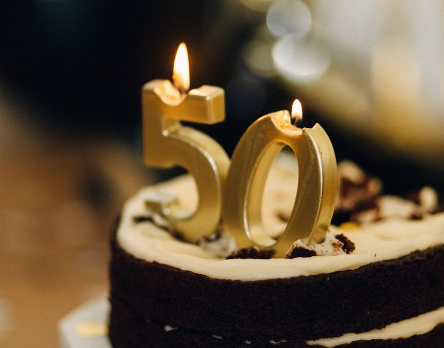 birthday cake with lighted candles on top